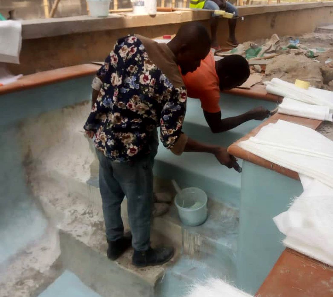 AquaCrystal Craft team building a fiberglass swimming pool in Nigeria